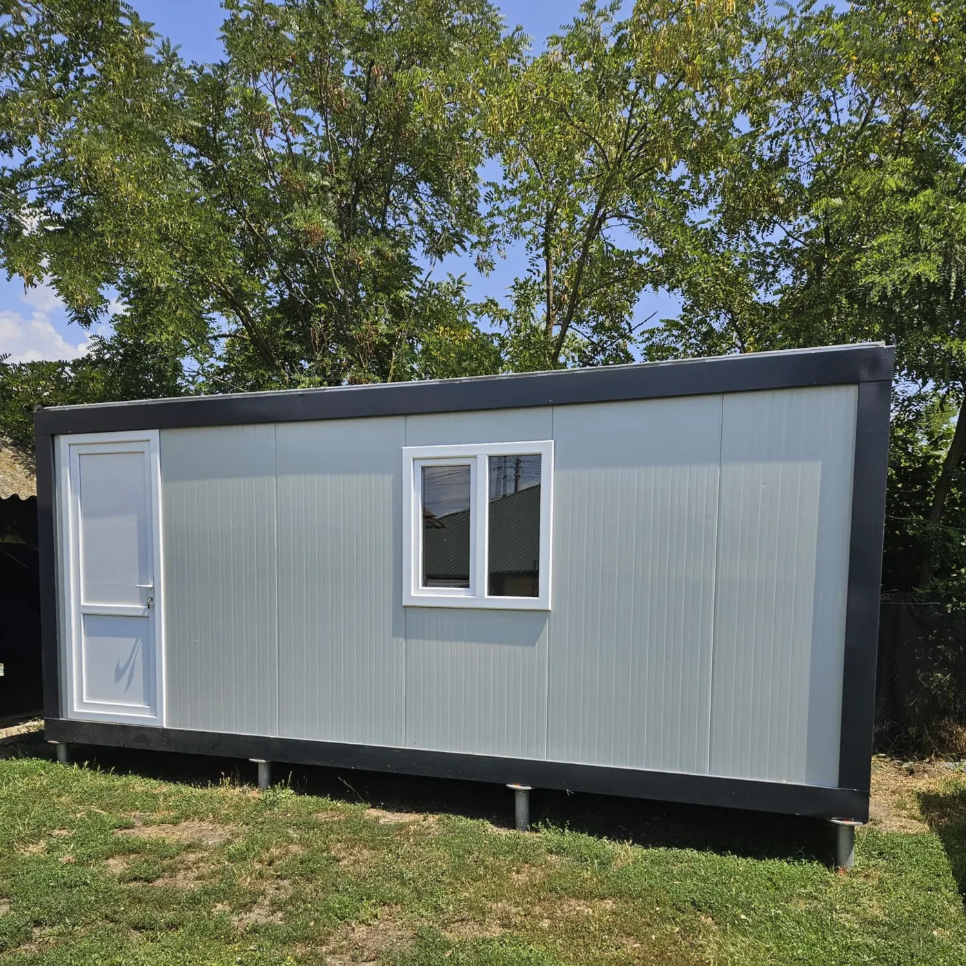 Modular container installed on MARTETIC foundation screws, with the ground-air transition zone visible